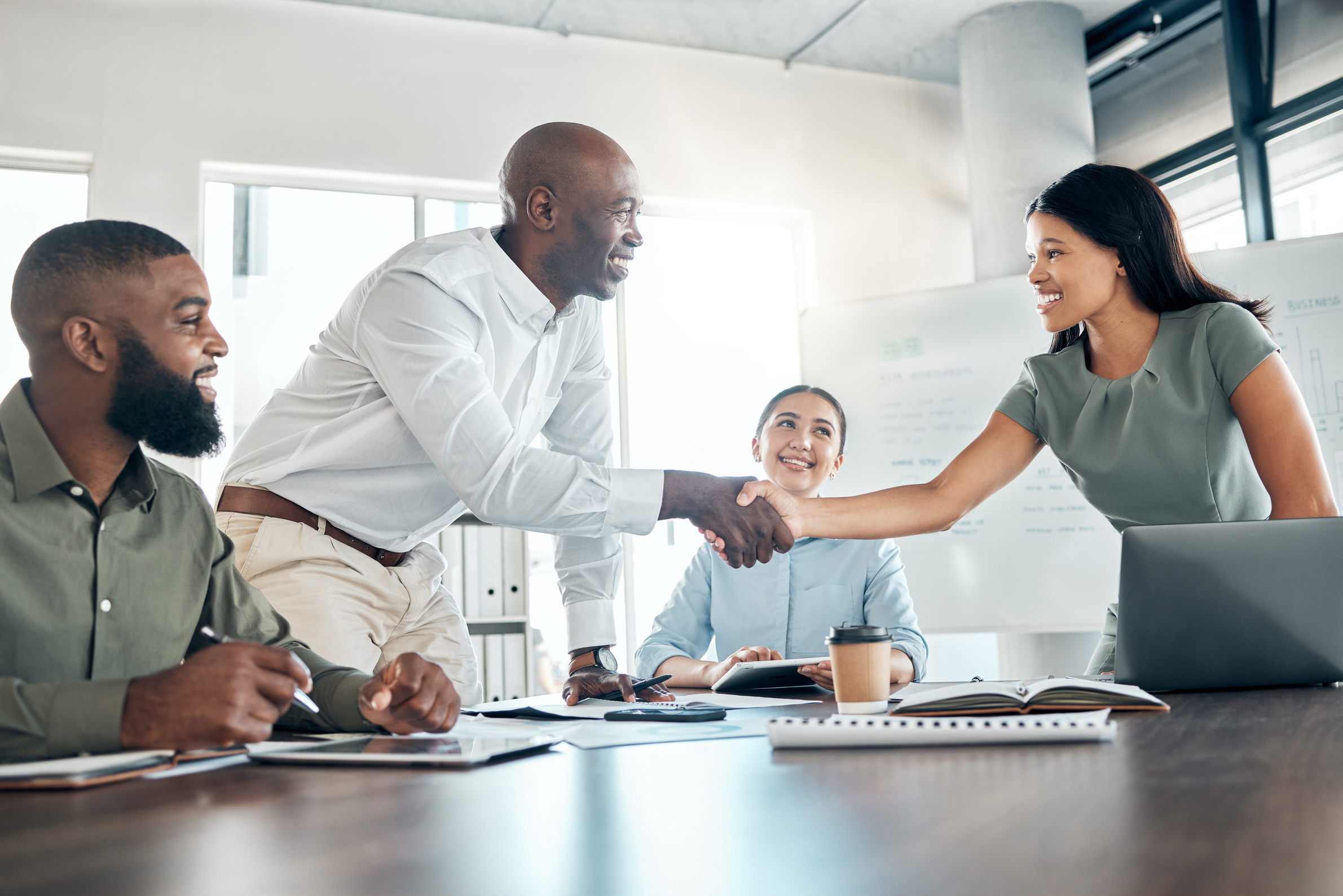 Handshake, Office Diversity and Meeting Welcome for Company Onboarding or Partnership Together. Introduction, Agreement and Negotiation with Workforce People in Corporate Company Boardroom.